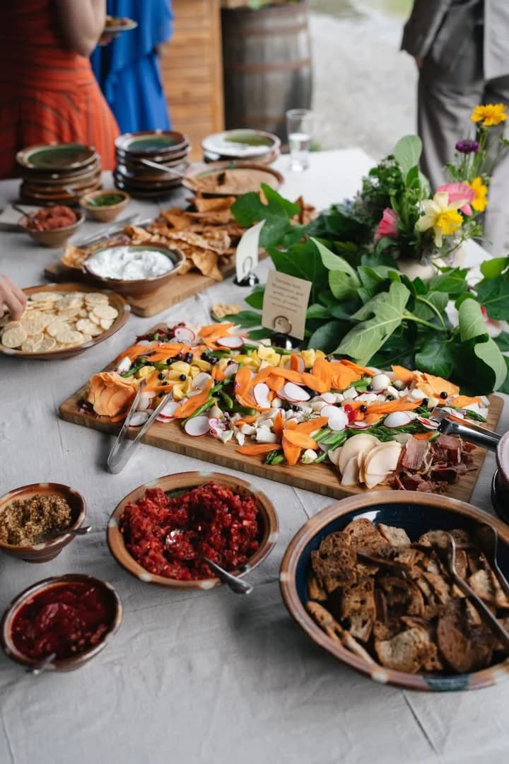 Charcuterie and radish spread on a long dinner table
