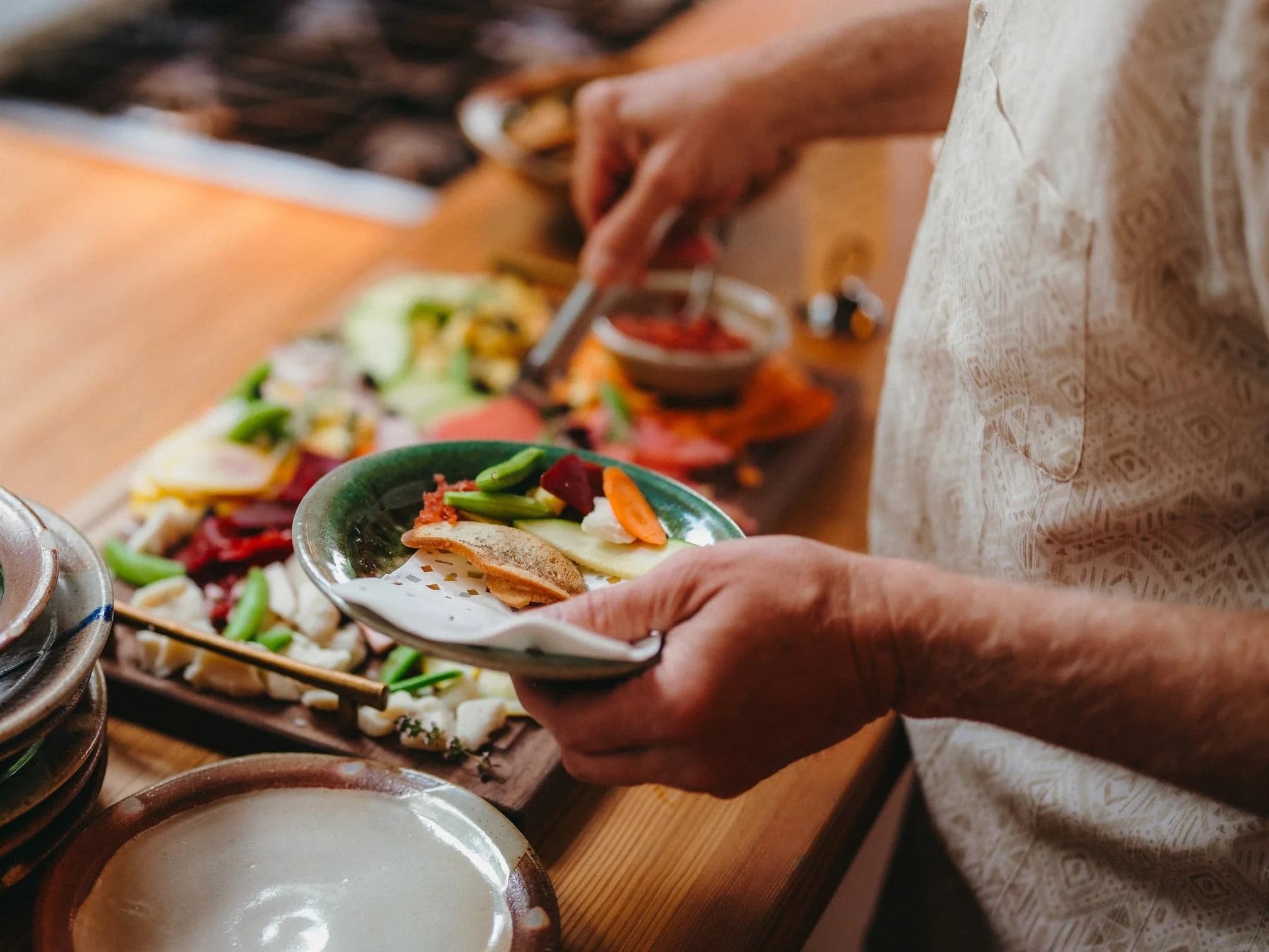 Chef plating a course at the farmhouse kitchen counter