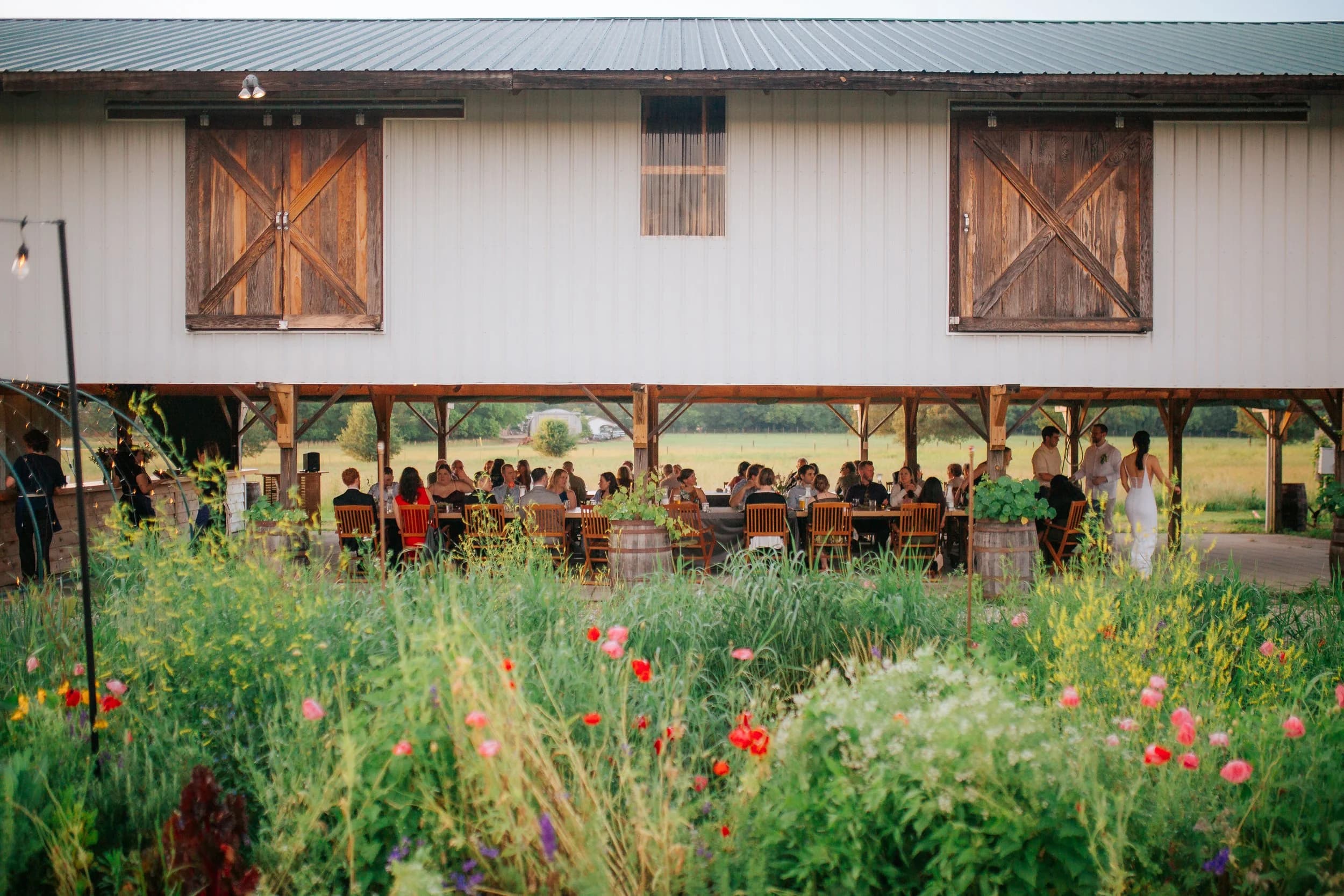 Wide view of the barn with a long reception table