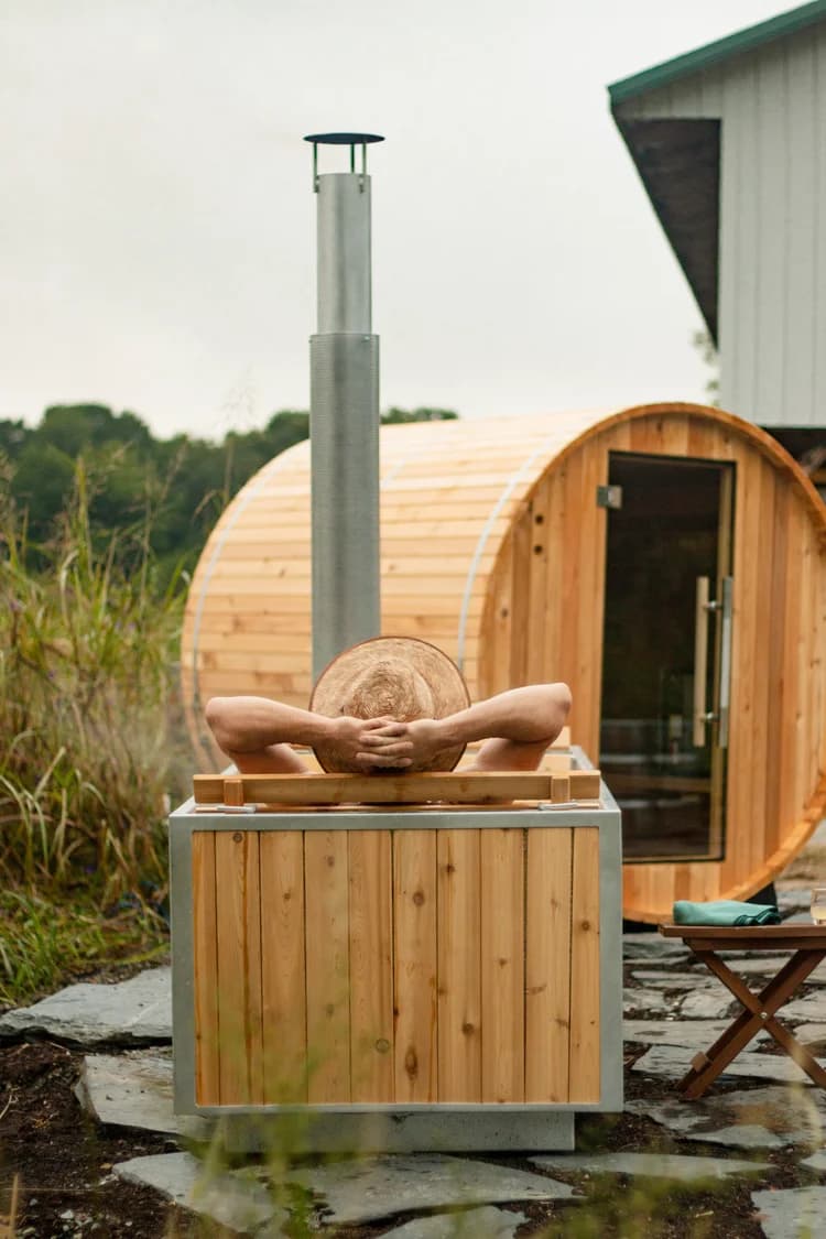 Cedar barrel sauna with cold plunge outside the barn