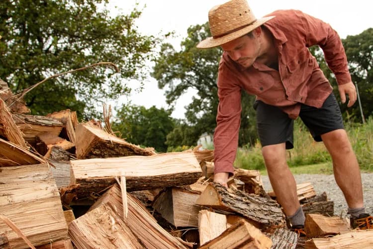 A farmer splitting cedar logs for the wood-fired sauna